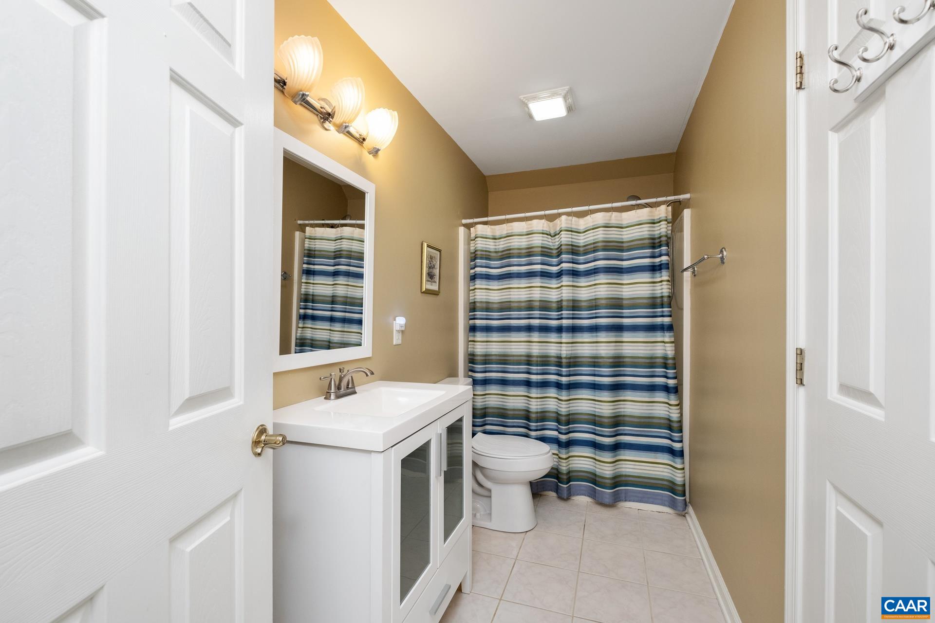 684 Campbell Road Keswick, VA 22947 - Photo 50 of 51 a bathroom with a sink toilet and shower