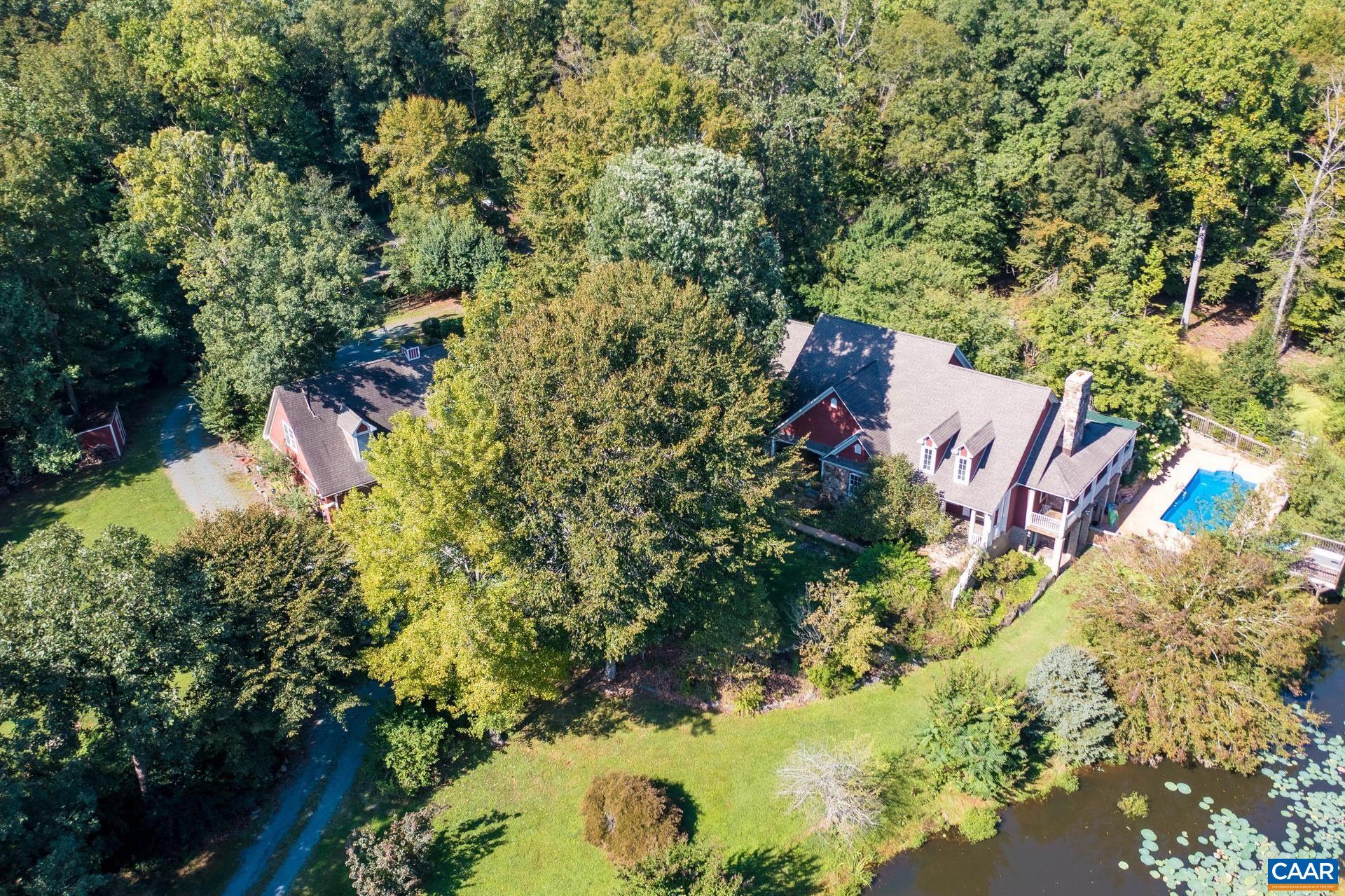 684 Campbell Road Keswick, VA 22947 - Photo 6 of 51 an aerial view of a house with a yard and large trees