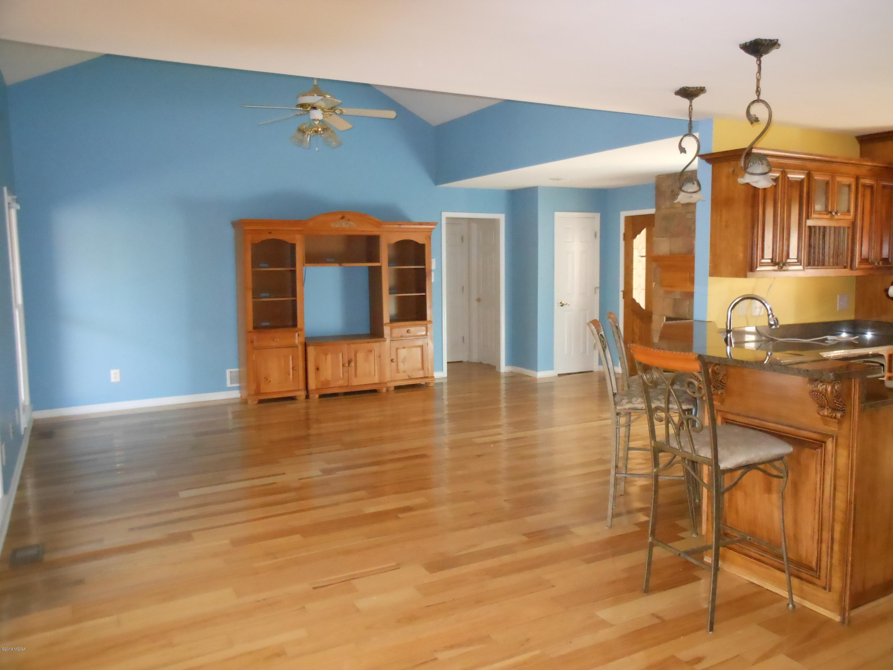 1248 Halls Bridge Road Jackson, GA 30233 - Photo 11 of 25 an empty room with wooden floor and windows