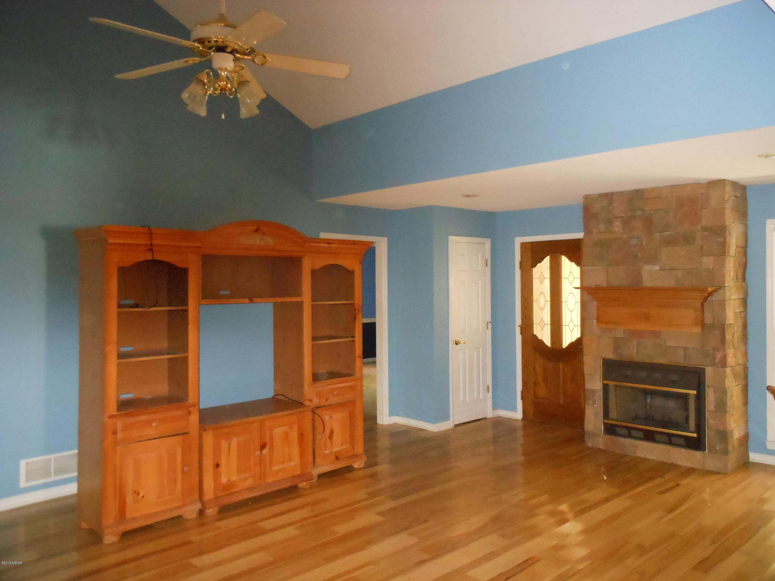 1248 Halls Bridge Road Jackson, GA 30233 - Photo 12 of 25 a view of a livingroom with wooden floor and a fireplace