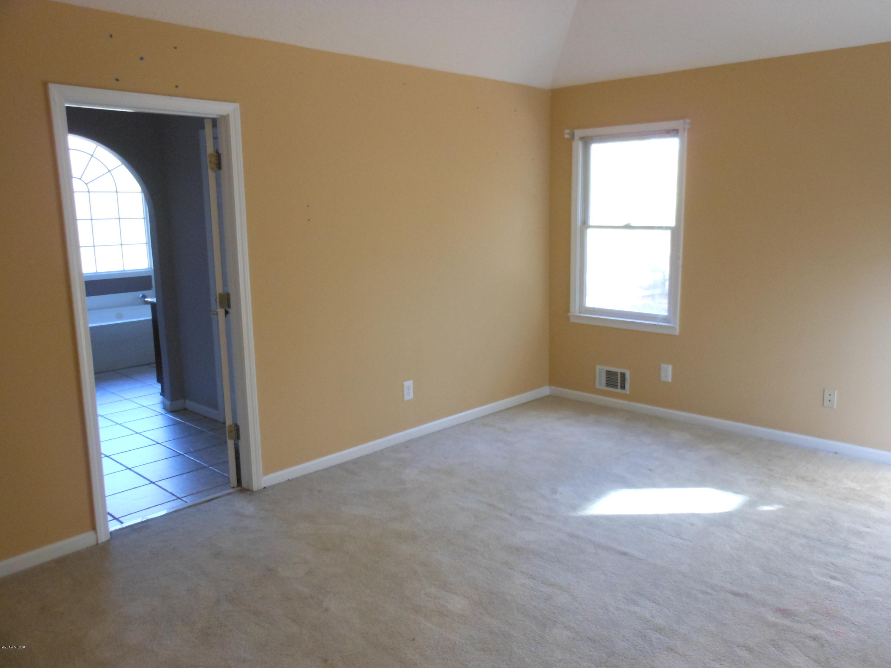 1248 Halls Bridge Road Jackson, GA 30233 - Photo 15 of 25 an empty room with windows and closet