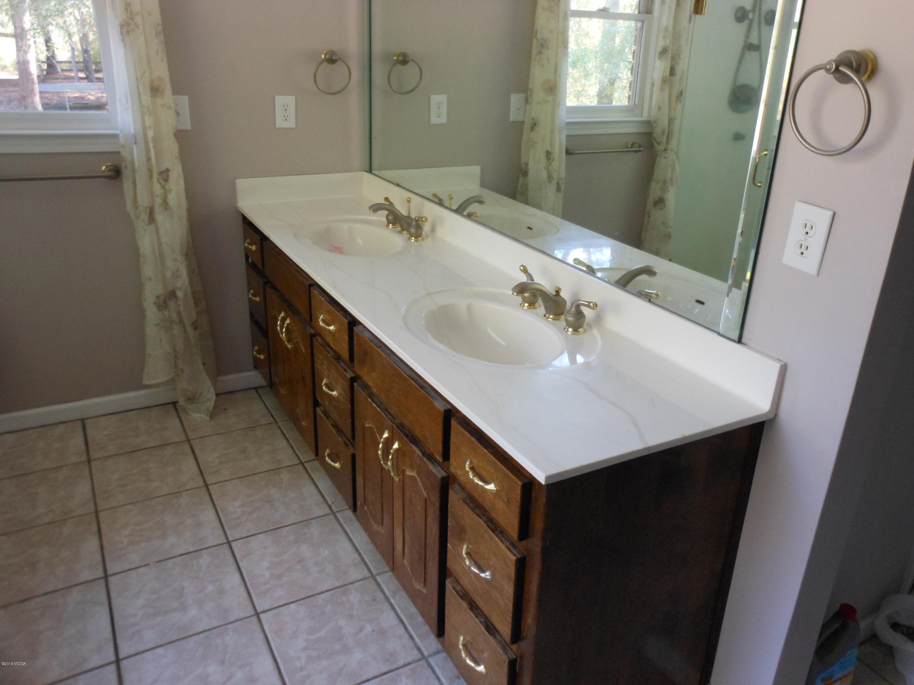 1248 Halls Bridge Road Jackson, GA 30233 - Photo 16 of 25 a bathroom with a sink and a mirror