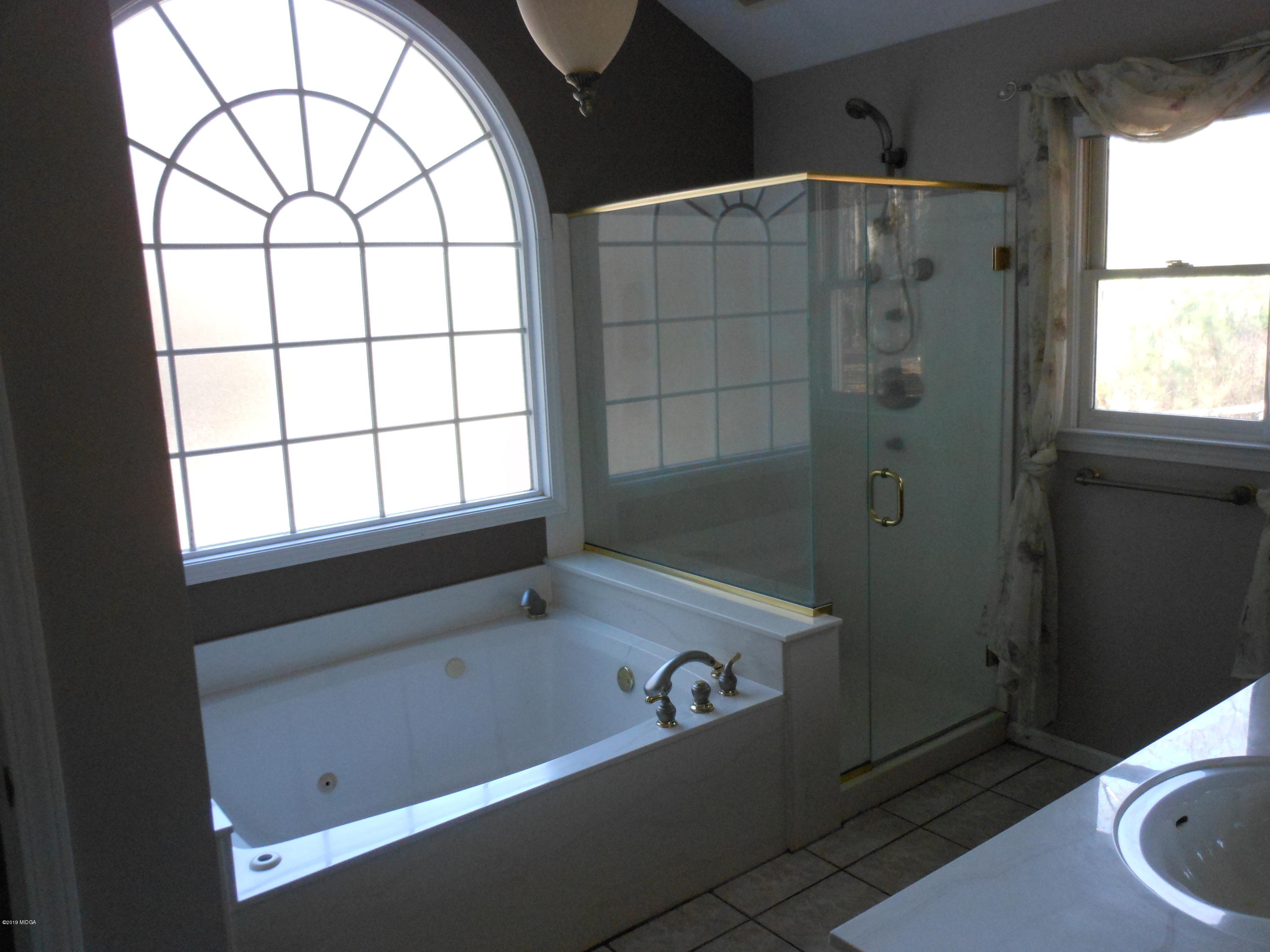 1248 Halls Bridge Road Jackson, GA 30233 - Photo 17 of 25 a bathroom with a bathtub and window