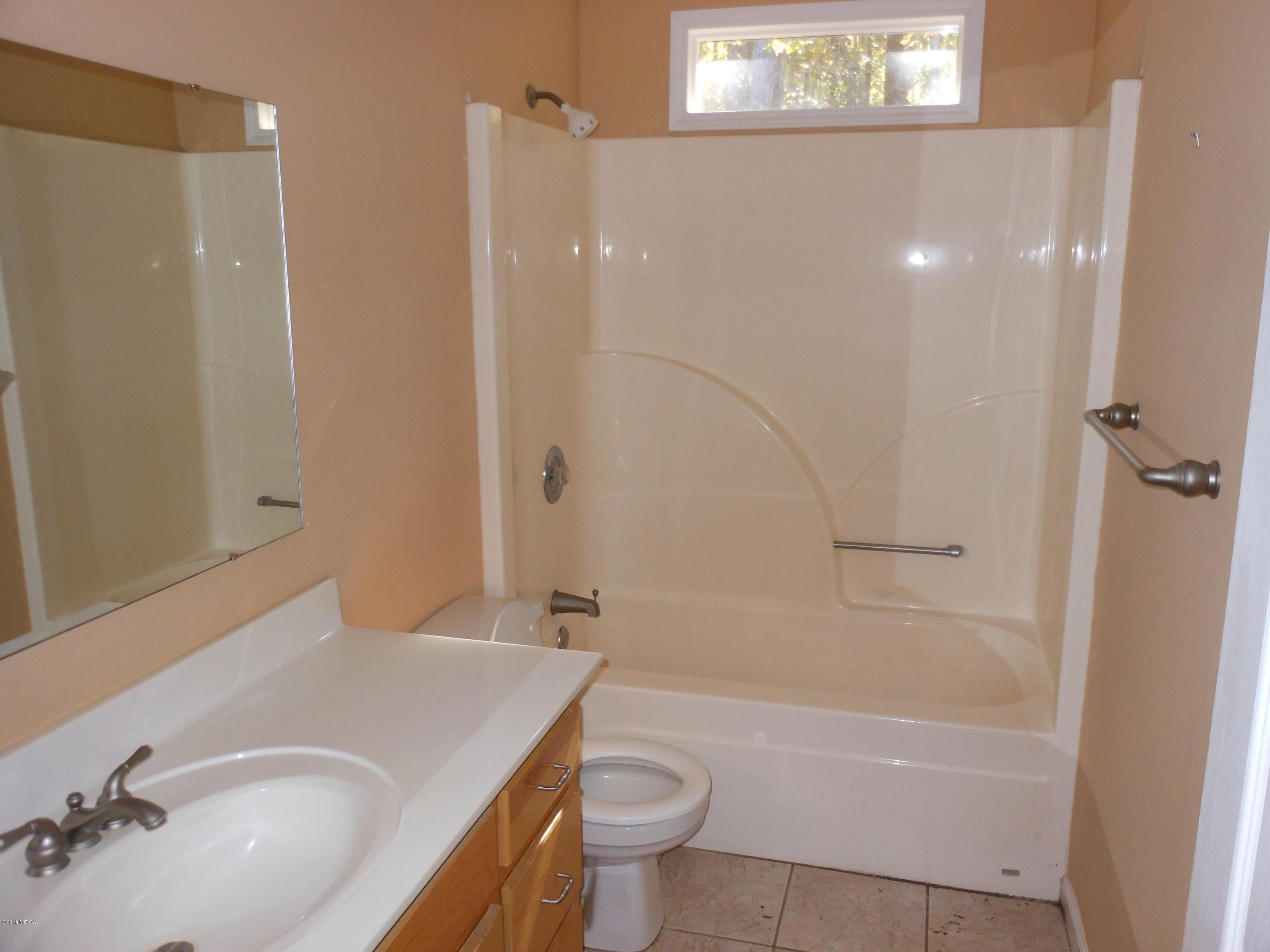1248 Halls Bridge Road Jackson, GA 30233 - Photo 20 of 25 a bathroom with a sink a toilet and shower