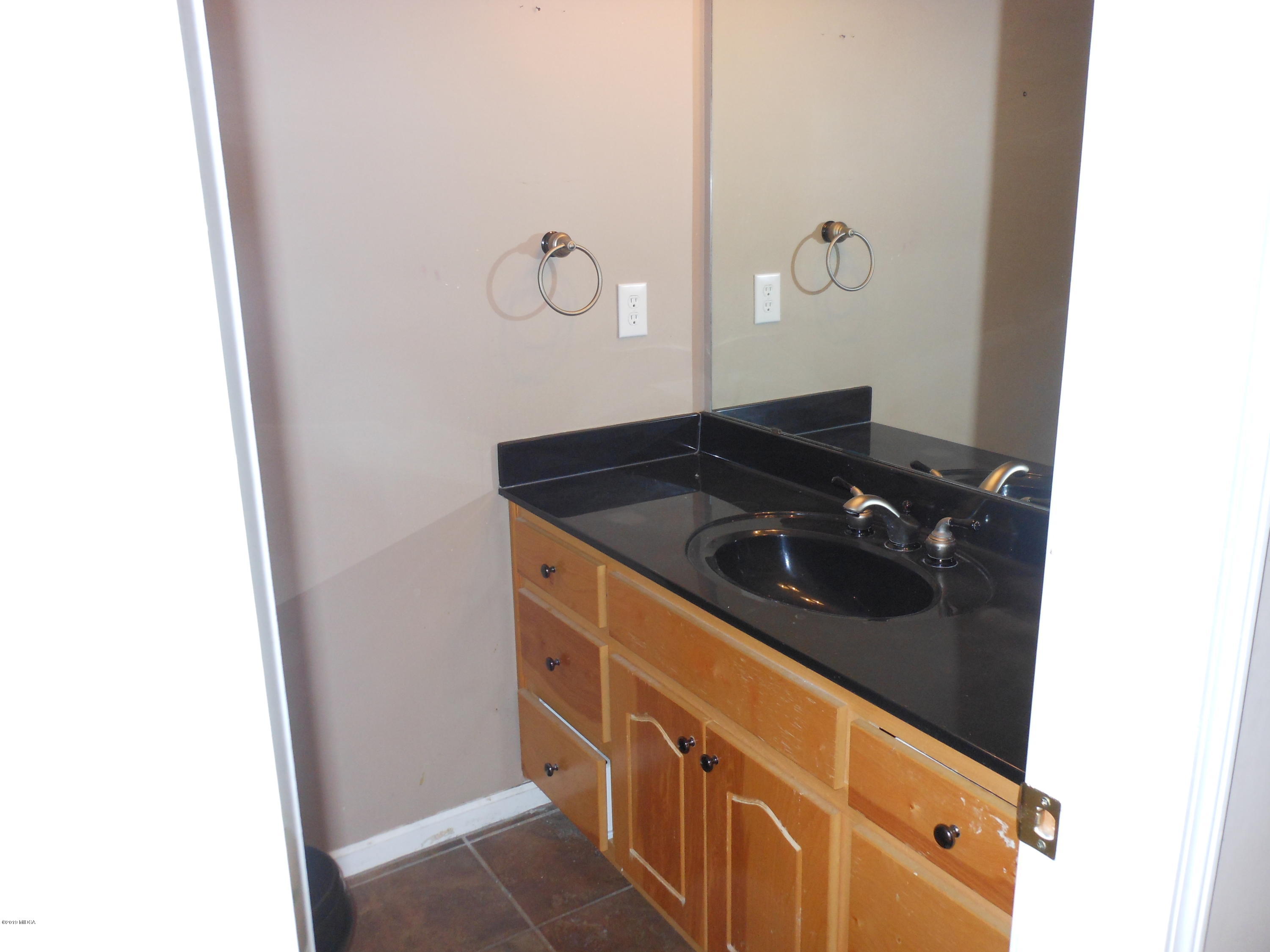 1248 Halls Bridge Road Jackson, GA 30233 - Photo 8 of 25 a bathroom with a sink and vanity