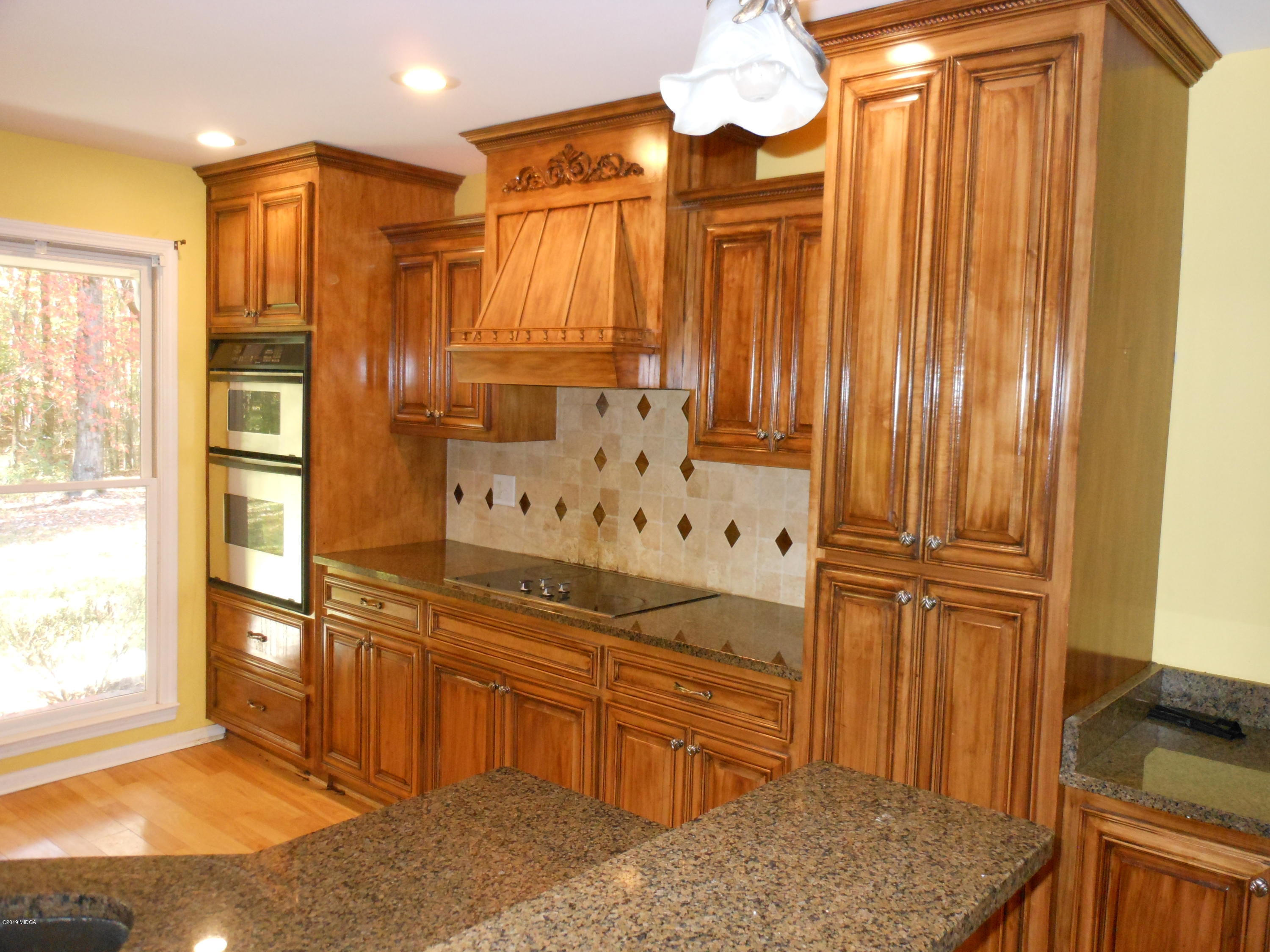 1248 Halls Bridge Road Jackson, GA 30233 - Photo 9 of 25 a bathroom with a granite countertop sink and a mirror