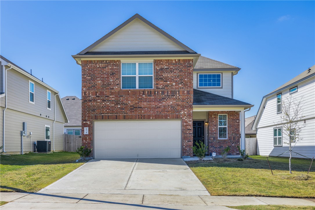 974 Harper Lane Bryan, TX 77803 - Photo 1 of 38 Traditional home with brick siding, driveway, an attached garage, and a shingled roof