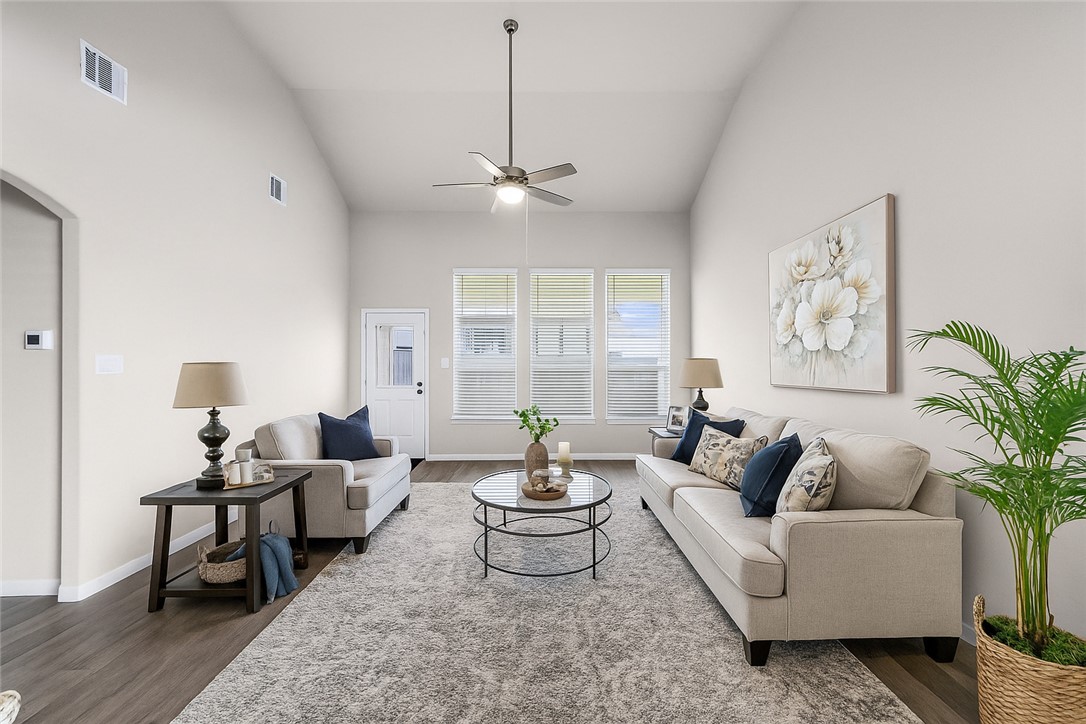 974 Harper Lane Bryan, TX 77803 - Photo 12 of 38 Living area featuring wood finished floors, a ceiling fan, high vaulted ceiling, and arched walkways