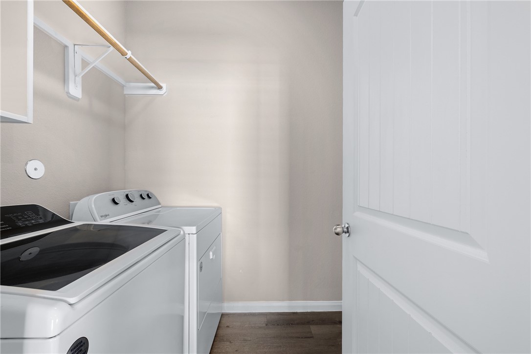 974 Harper Lane Bryan, TX 77803 - Photo 14 of 38 Washroom with dark wood-type flooring and separate washer and dryer