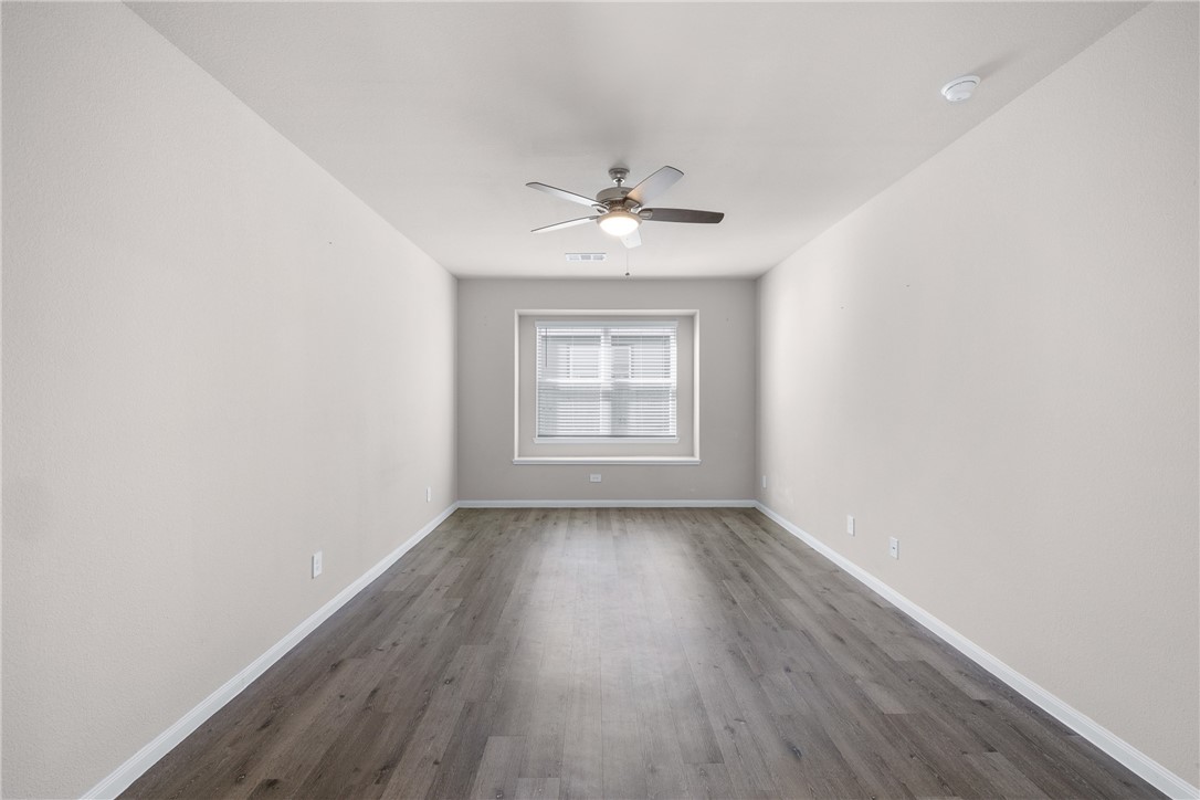 974 Harper Lane Bryan, TX 77803 - Photo 16 of 38 Spare room with dark wood-style floors and ceiling fan