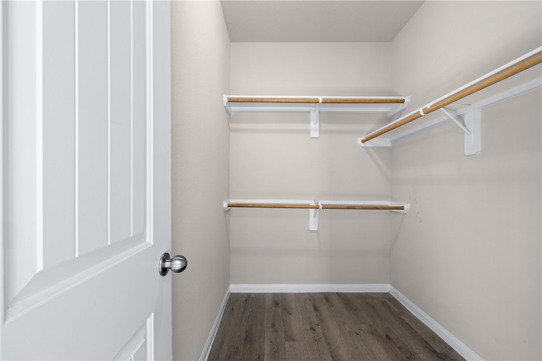 974 Harper Lane Bryan, TX 77803 - Photo 20 of 38 Walk in closet featuring dark wood-style flooring