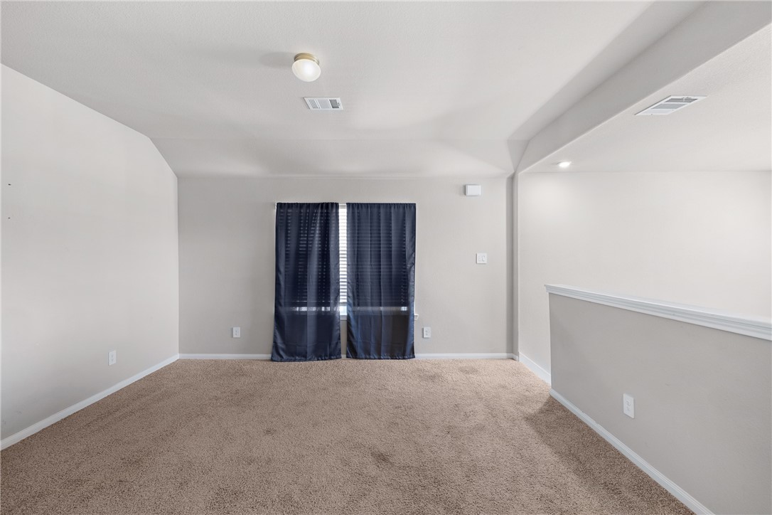 974 Harper Lane Bryan, TX 77803 - Photo 23 of 38 Unfurnished room featuring carpet and baseboards