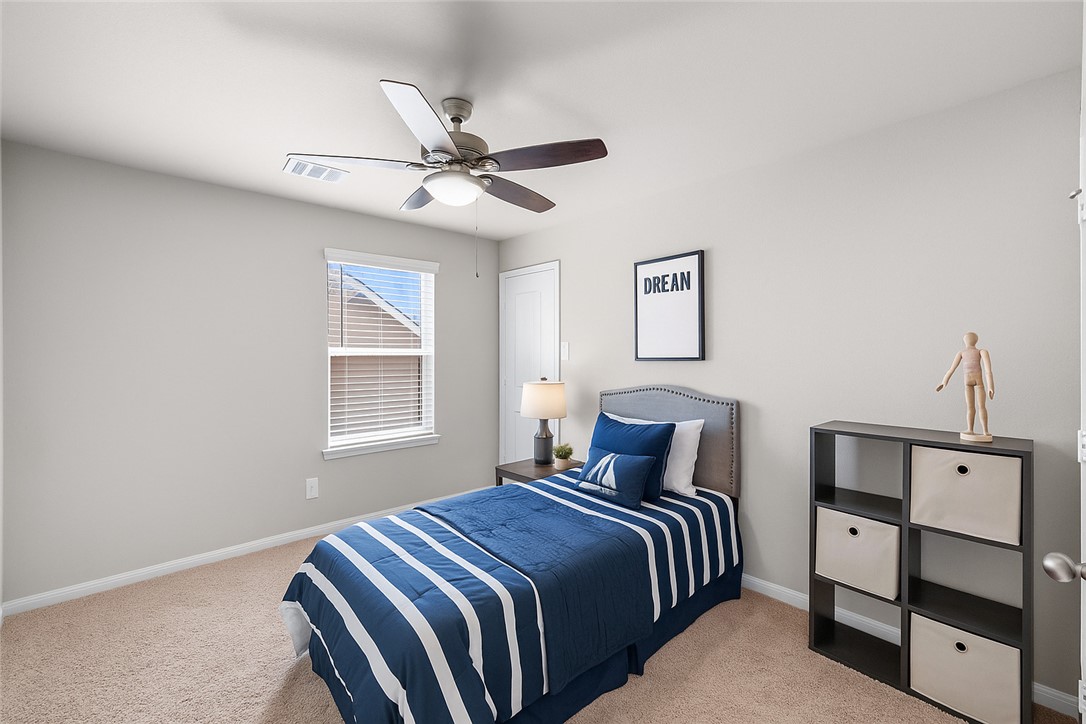 974 Harper Lane Bryan, TX 77803 - Photo 25 of 38 Bedroom with light colored carpet and ceiling fan