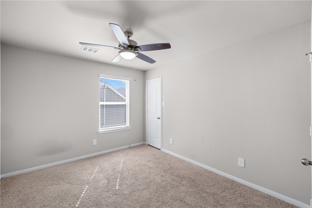 974 Harper Lane Bryan, TX 77803 - Photo 26 of 38 Carpeted empty room featuring baseboards and a ceiling fan