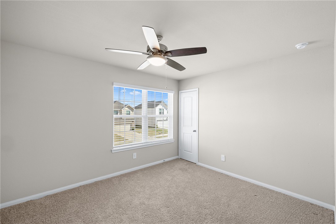 974 Harper Lane Bryan, TX 77803 - Photo 30 of 38 Carpeted spare room with baseboards and a ceiling fan