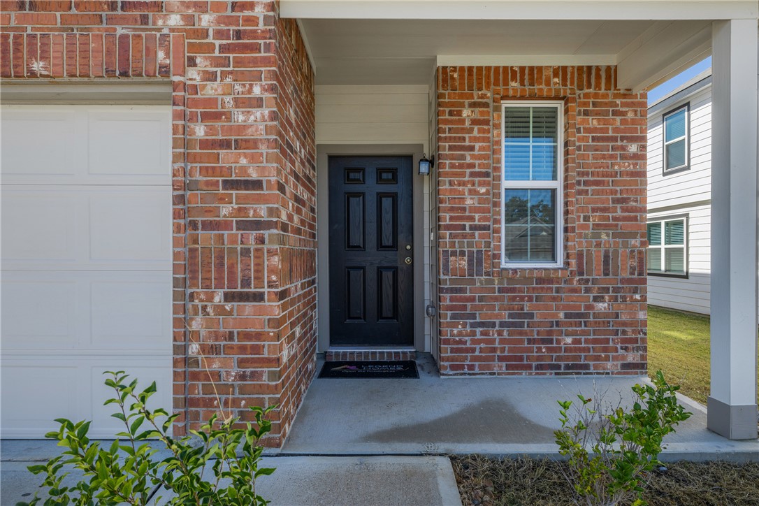 974 Harper Lane Bryan, TX 77803 - Photo 5 of 38 Property entrance with brick siding and covered porch