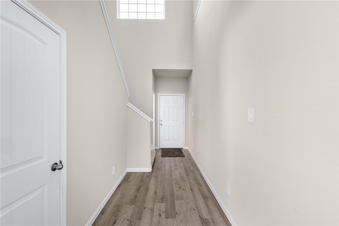 974 Harper Lane Bryan, TX 77803 - Photo 6 of 38 Corridor featuring wood finished floors and a high ceiling