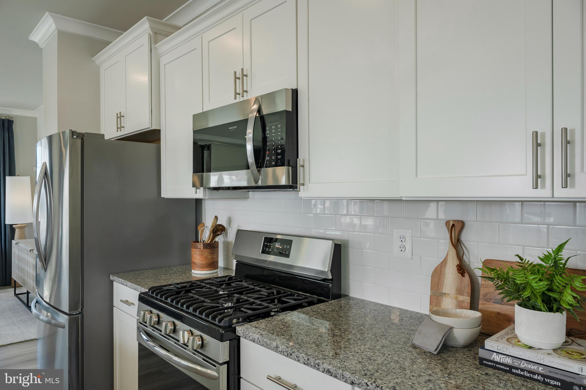 1845 Ritter Road Windsor Mill, MD 21244 - Photo 6 of 14 a kitchen with stainless steel appliances granite countertop a stove a refrigerator a sink a counter space and cabinets