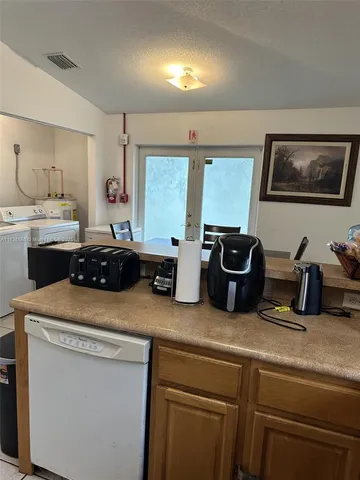 a kitchen with a sink appliances and cabinets