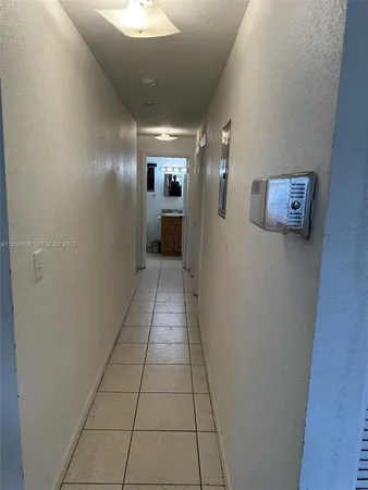 a view of a hallway to a livingroom with furniture