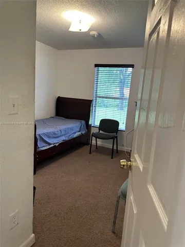a bedroom with a bed and a chair