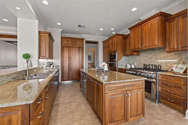 a kitchen with stainless steel appliances granite countertop a stove and a refrigerator