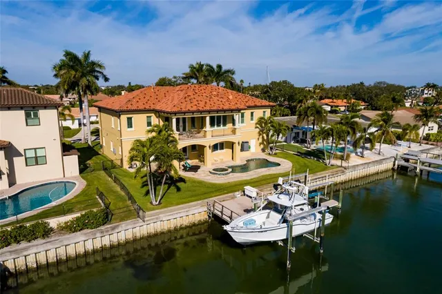 a view of a house with pool and chairs