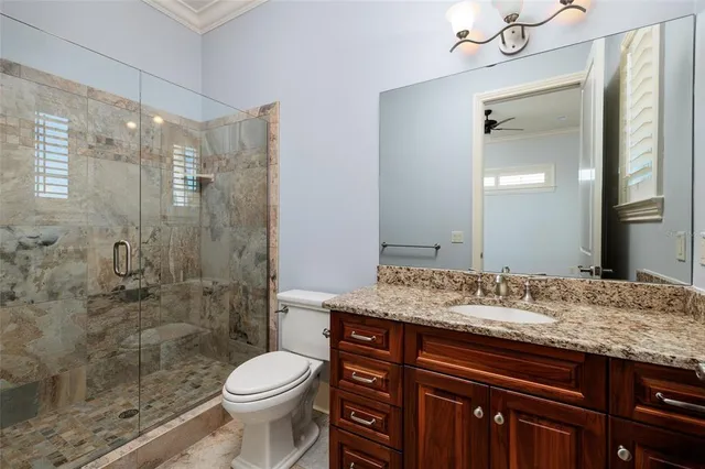 a kitchen with stainless steel appliances granite countertop a sink window and cabinets