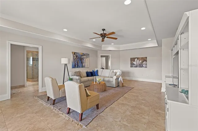 a spacious bedroom with a bed and wooden floor