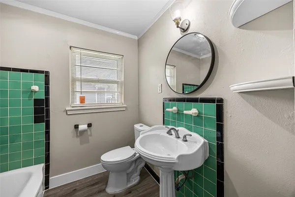 a bathroom with a sink toilet and a mirror