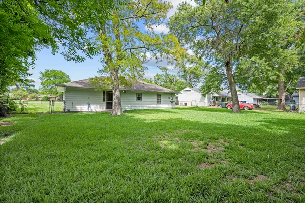 a view of house with backyard