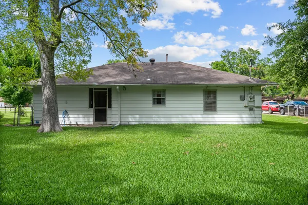 a front view of house with yard and outdoor seating