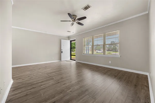 wooden floor in an empty room with a window