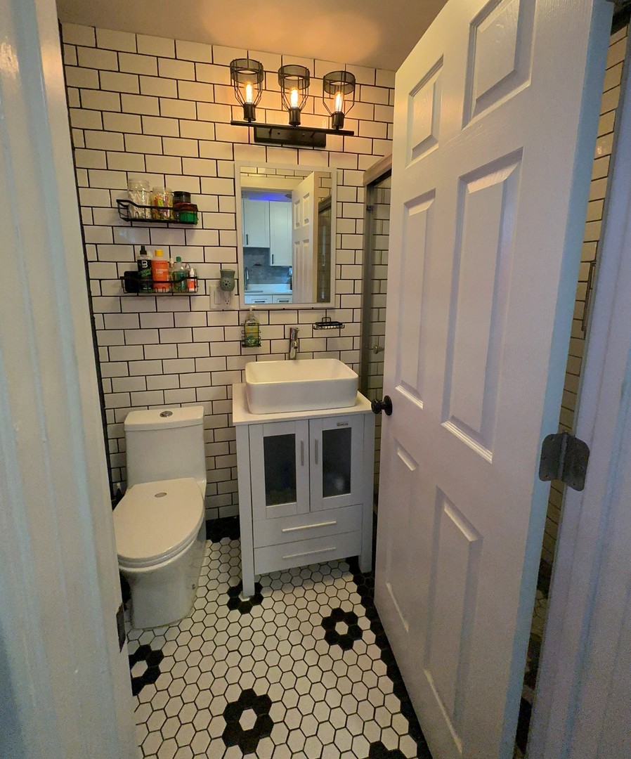 3062 South Lyman Street, Unit 2 Chicago, IL 60608 - Photo 4 of 7 a bathroom with a toilet and a shower