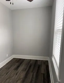 a view of an empty room and wooden floor
