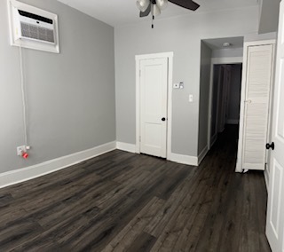 3062 South Lyman Street, Unit 2 Chicago, IL 60608 - Photo 6 of 7 a view of an empty room with wooden floor and a window