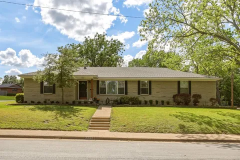 a front view of house with yard and green space