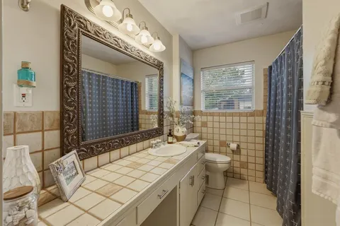 a bathroom with a sink mirror and a bathtub