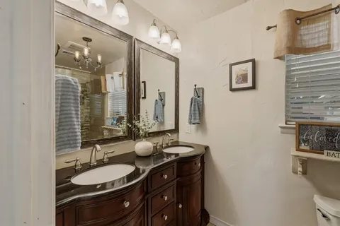 a bathroom with a double vanity sink and a mirror