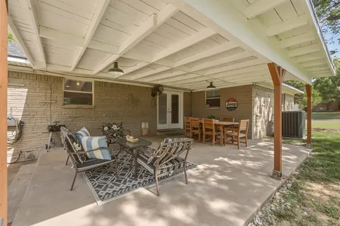 a view of a patio with table and chairs and potted plants