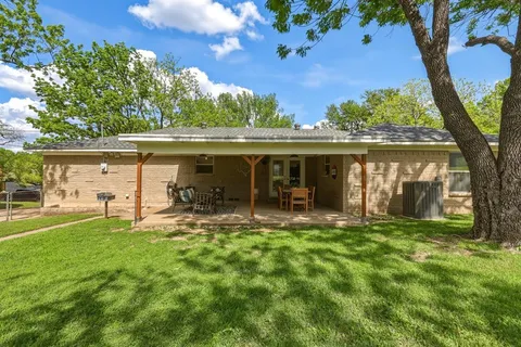 a view of a house with a yard balcony and sitting area