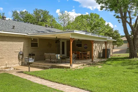 a view of a house with backyard porch and sitting area