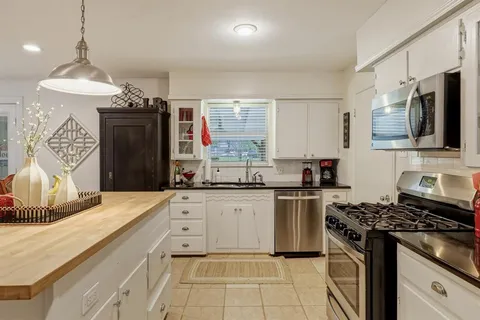 a kitchen with stainless steel appliances granite countertop a stove and a sink