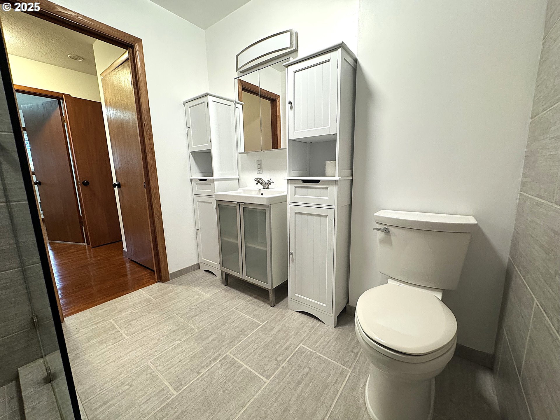 2442 Southeast 190th Avenue Portland, OR 97233 - Photo 21 of 36 a bathroom with a toilet sink and a mirror