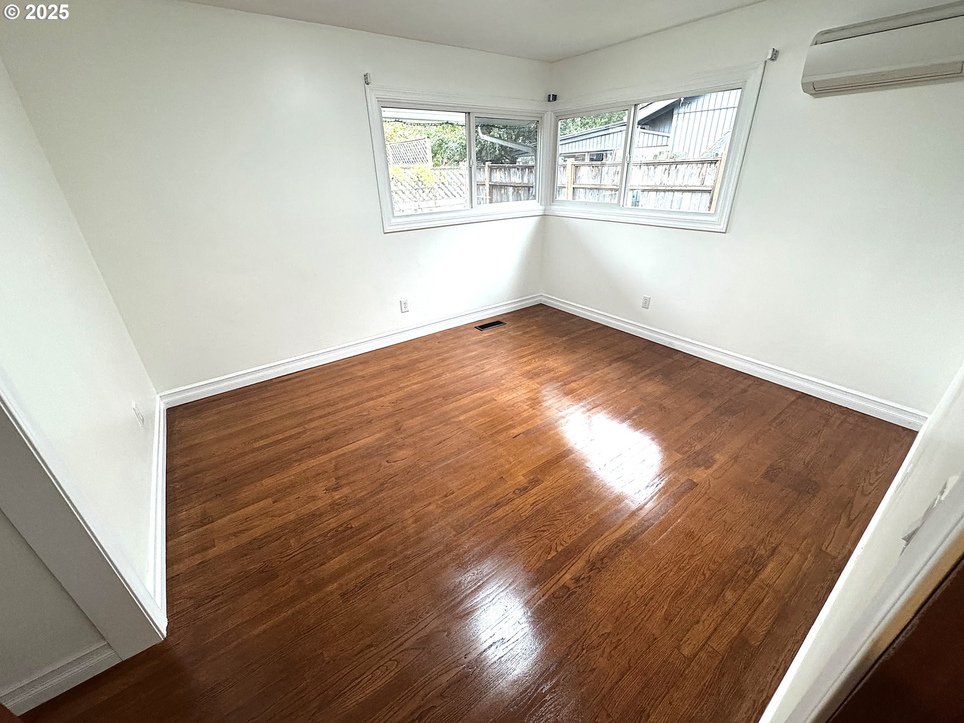 2442 Southeast 190th Avenue Portland, OR 97233 - Photo 22 of 36 an empty room with wooden floor and windows