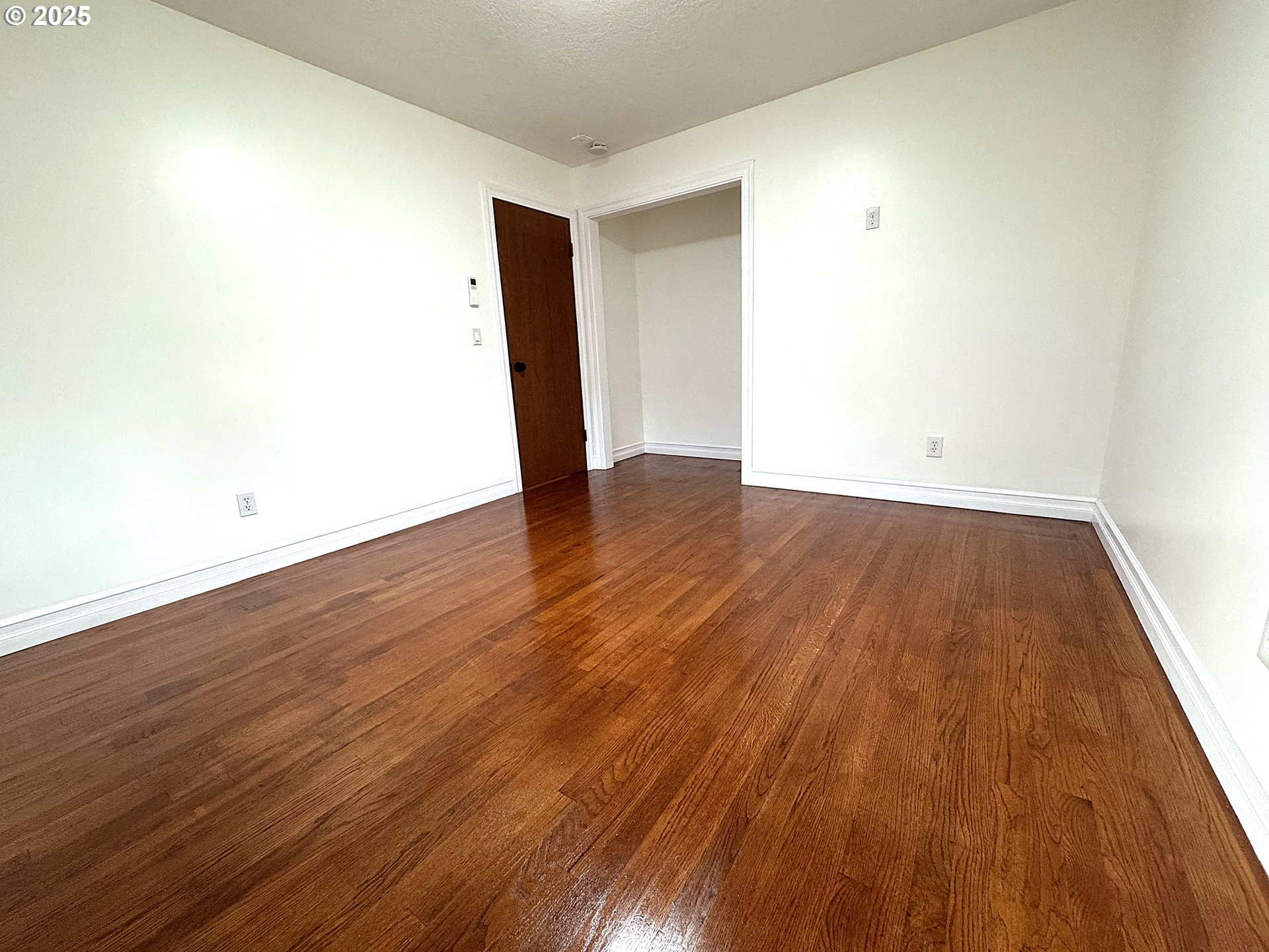 2442 Southeast 190th Avenue Portland, OR 97233 - Photo 23 of 36 a view of an empty room with wooden floor