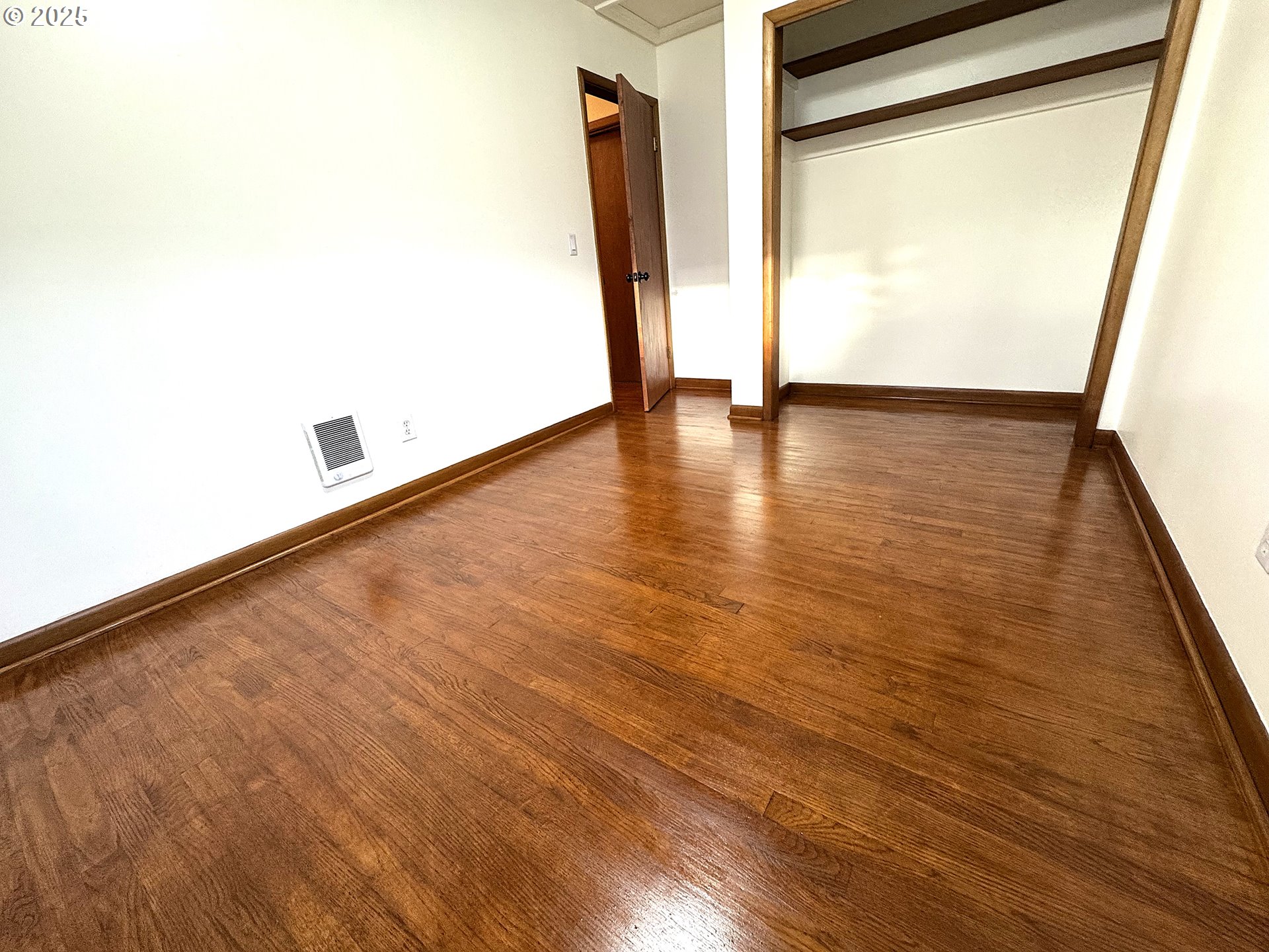 2442 Southeast 190th Avenue Portland, OR 97233 - Photo 26 of 36 an empty room with wooden floor and door
