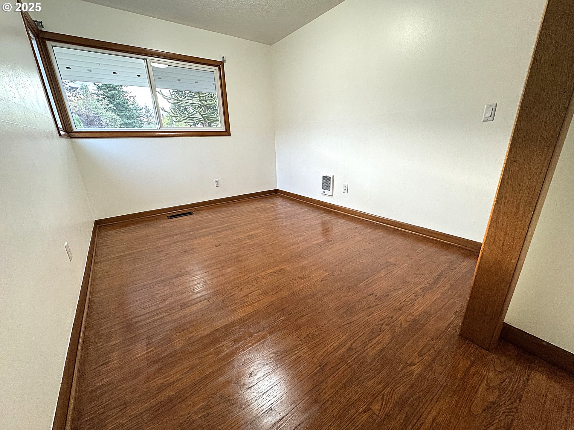 2442 Southeast 190th Avenue Portland, OR 97233 - Photo 27 of 36 an empty room with wooden floor and window