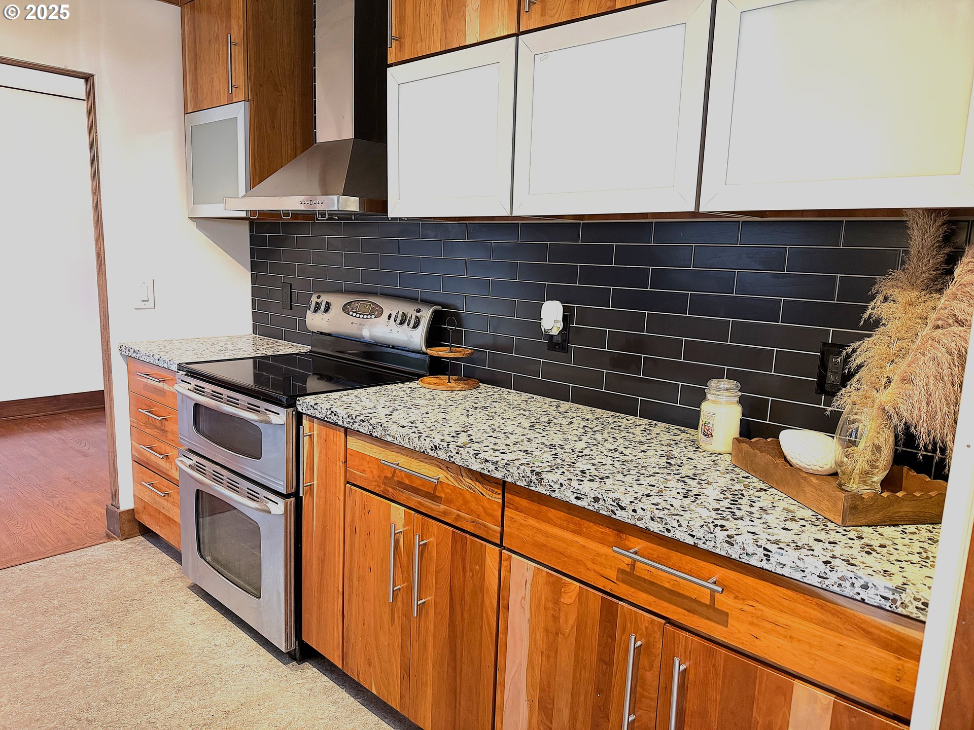 2442 Southeast 190th Avenue Portland, OR 97233 - Photo 6 of 36 a kitchen with granite countertop cabinets and stove top oven