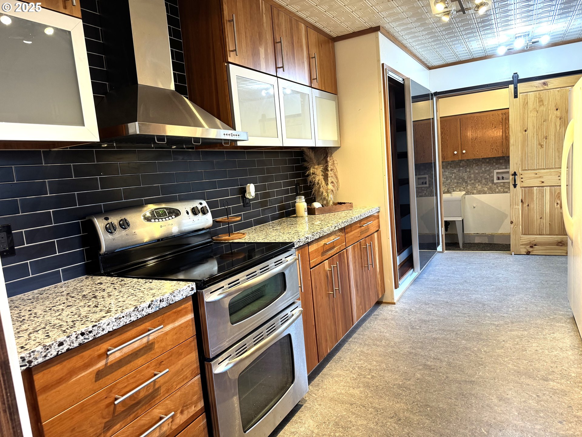 2442 Southeast 190th Avenue Portland, OR 97233 - Photo 9 of 36 a kitchen with a stove and a cabinet